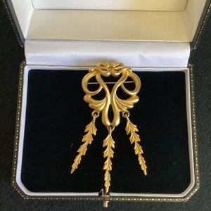 Vintage A J C gold tone brooch.